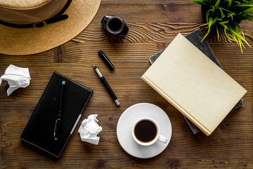 Writer's block concept. Notebook, pen, crumpled paper on dark wooden background top-down flay lay