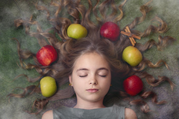 Fototapeta na wymiar Image of a beautiful girl with apples in her hair