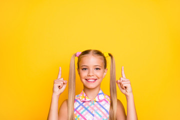 Closeup photo of cheerful little lady good mood long tails direct fingers up empty space show...