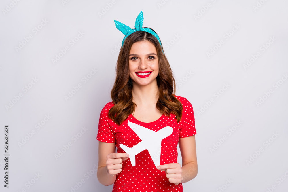 Poster Portrait of positive cheerful girl hold white paper card plane enjoy traveling weekend tour air wear vintage style stylish trendy outfit isolated over grey color background