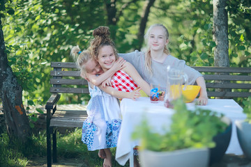 children rest in the summer in nature, girls sisters have fun outdoors