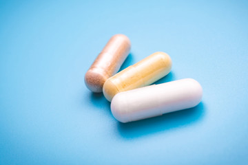 capsules with vitamins on a blue background