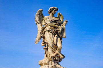 Fototapeta na wymiar Statue of angel on Ponte Sant'Angelo, a Roman bridge in Rome, Italy