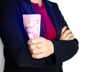 Close-up business woman wearing suit holding thai money notes.