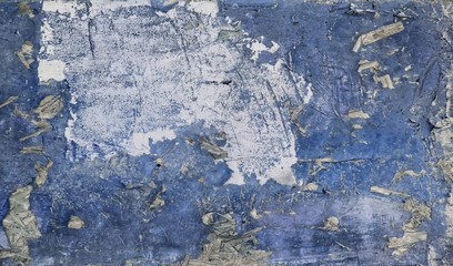 Abstract background with grunge textures. Photo of an old blue-painted chipboard. Vintage horizontal colorful background, grunge background with space for text or image. Old destroyed plywood.