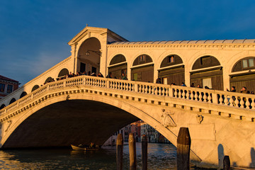 Fototapeta na wymiar Rialto Bridge (Ponte de Rialto) across Grand Canal at sunrise / sunset time, Venice, Italy
