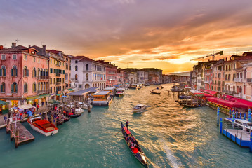 Fototapeta na wymiar The Grand Canal with gondola and vaporetto at sunset time, Venice, Italy