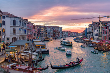 Fototapeta na wymiar The Grand Canal with gondola and vaporetto at sunset time, Venice, Italy