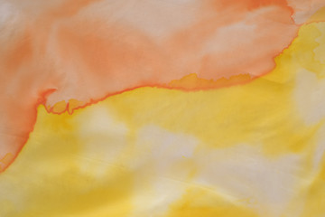 close up of hand colored orange and yellow silk scarf