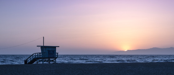 Sunset on the beach in California, Coast Guard rescue shed - obrazy, fototapety, plakaty