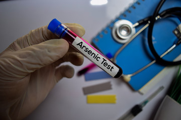 Arsenic Test text with blood sample. Top view isolated on office desk. Healthcare/Medical concept