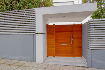 Obraz na płótnie Canvas sidewalk by modern house entrance wooden door