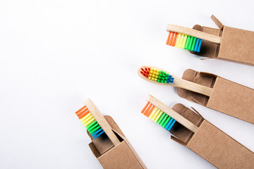 Bamboo toothbrushes in a cardboard packaging with copy space on a white background