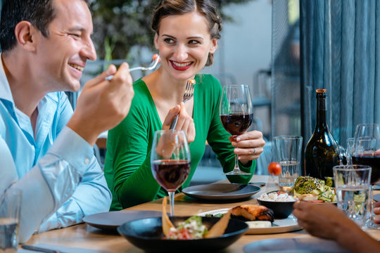 People Having Fun Eating And Drinking In A Upscale Restaurant