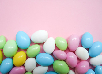 colorful almond candies  on a pink background