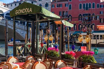 View of the Grand Canal, Rialto Bridge, and gondolas from outdoor restaurant seats, Venice, Italy