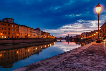 Fototapeta na wymiar Pisa Italy 11/03/2018: Pisan lungarnos, adorned with wonderful buildings and bridges are the most picturesque and famous places in Pisa, and among the most romantic for sure.Pisa Tuscany Italy
