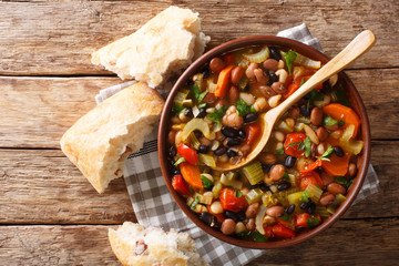 Healthy vegetarian three beans soup with vegetables in a bowl close-up. Horizontal top view