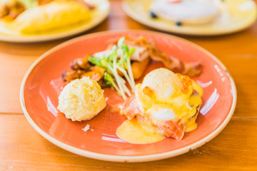 Eggs benedict with smoked salmon bacon and potato