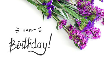 Purple flower and birthaday card on white background.