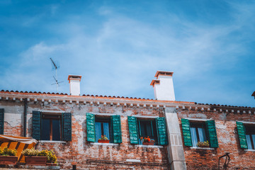 Italy. Venice old house with vintage facade with wood windows on the street