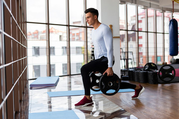 Side view of man doing lunges