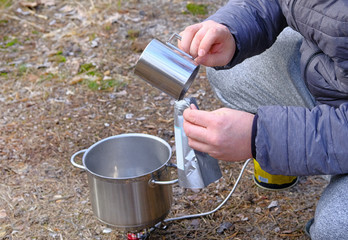 Traveler is eating freeze dried food during camping. Enjoy a tasty food during hiking trips....