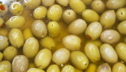 Green olives in brine in supermarket.