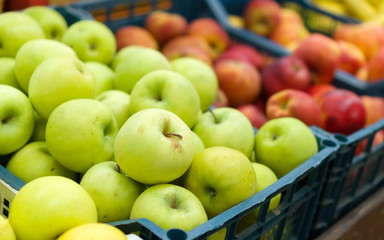 Fruit baskets in the market. Red and green apples.