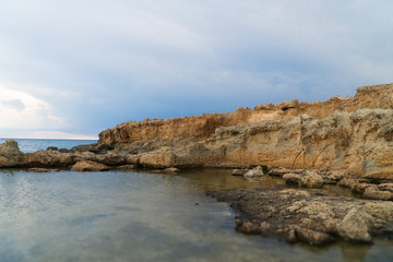 Fototapeta na wymiar Beautiful lava stones on the Cyprus seashore.