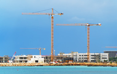 Fototapeta premium Lots of construction cranes near Ayia Napa in Cyprus.