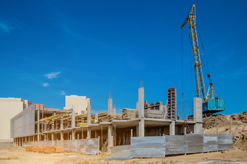 Construction site background. Hoisting cranes and new multi-storey buildings. I.ndustrial...