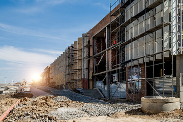 Construction site background. Hoisting cranes and new multi-storey buildings. I.ndustrial...