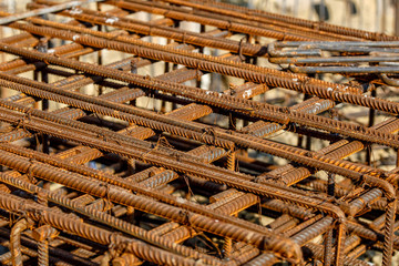 steel rebar for reinforcement concrete at construction site with house under construction background,Industrial background.Rusty rebar for concrete pouring.