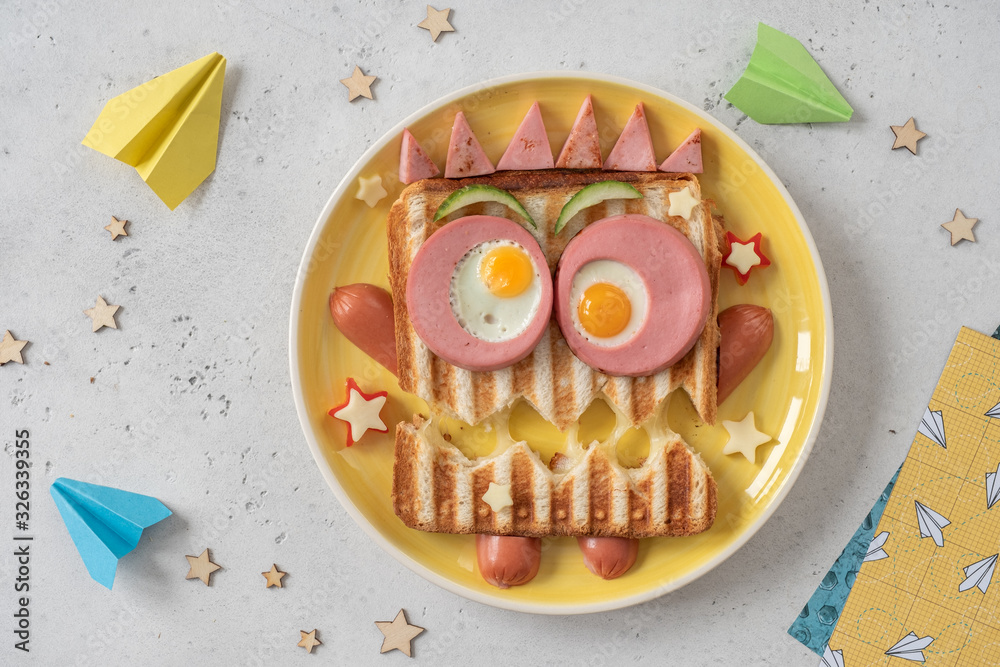 Wall mural fun halloween monster sandwich with slice meat sausage, eggs and cheese on plate