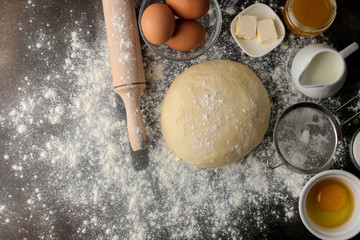 Dough for baking. making delicious cookies. Ingredients for the dough, eggs, flour, butter, sugar on a dark background. top view