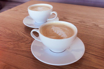 Two cups of cappuccino with latte art