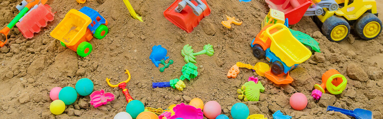 lot of children's toys in the sandbox. Selective focus.
