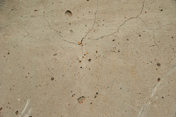 Abstract background. Smooth concrete wall of light gray color with large cracks. Structure, background.