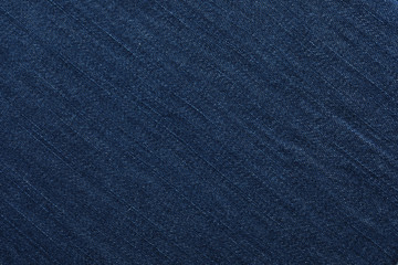 Texture of dark blue jeans as background, closeup