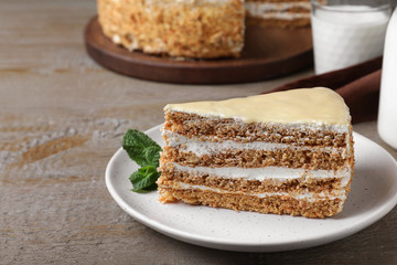 Delicious cake with condensed milk on wooden table