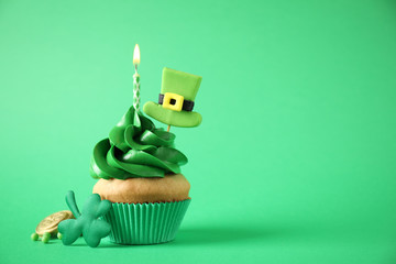 Decorated cupcake on green background, space for text. St. Patrick's Day celebration