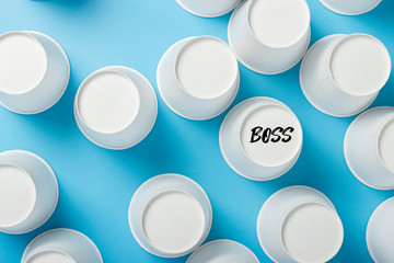 Inverted paper cups on a blue background. Banner. Flat lay, top view