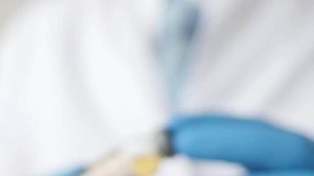 Medical doctor or laborant holding tube with nCoV Coronavirus vaccine for 2019-nCoV COVID virus. Novel Coronavirus originating in Wuhan, China. Coronavirus 2019-nCoV COVID concept.