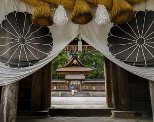Man standing in the Kumano Hongu Taisha, one of the three grand shrines of Kumano in traditional shinto architecture, in Tanabe, Wakayama, Japan