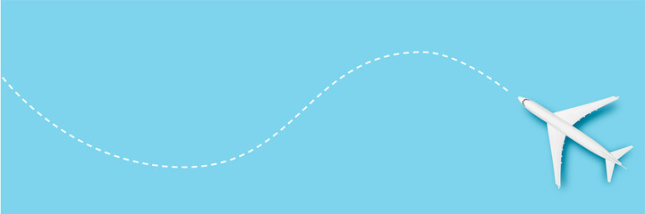 Airplane and line indicating the route on a blue background. Concept travel, airline tickets,...