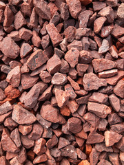 Close up view of red stone chippings