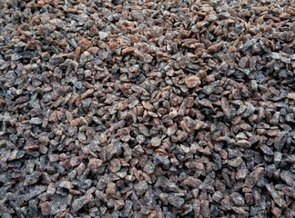 Stone texture background. Crushed gravel as background or texture. Granite gravel. Granite crumb close-up. Background. Texture. Brown. Structure.