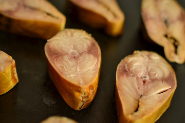 Hot smoked mackerel. Fish on a dark background, close-up.Fish pieces