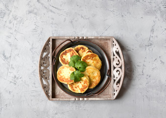 Potato pancakes in a pan on a gray background. Lenten menu.